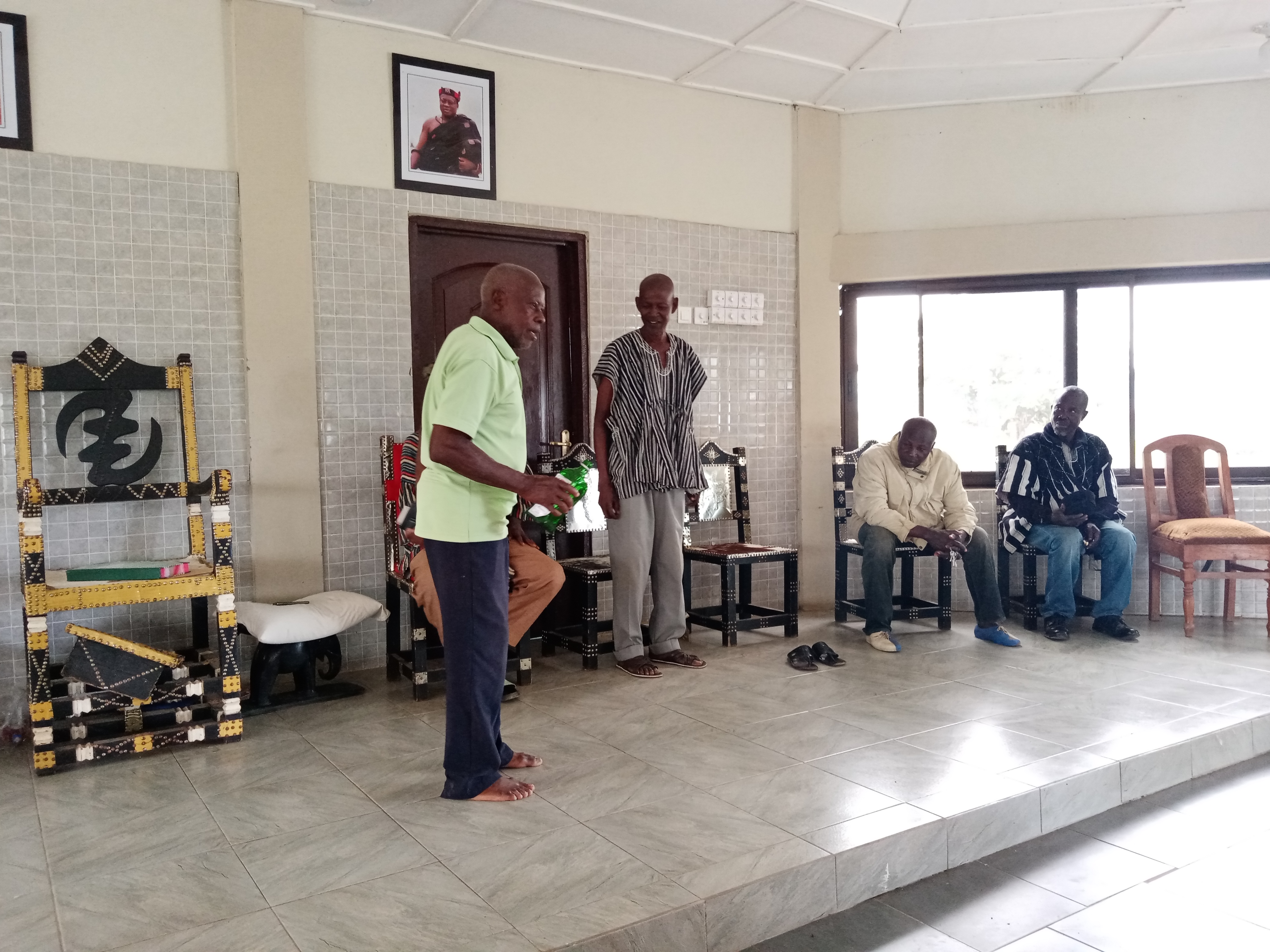 A speaker addressing people seated in a meeting hall